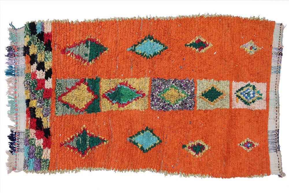 Vintage boucherouite rug orange background and designs