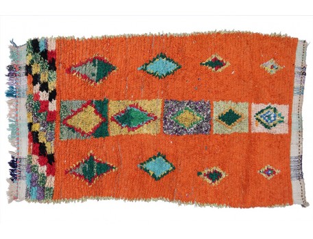 Vintage boucherouite rug orange background and designs