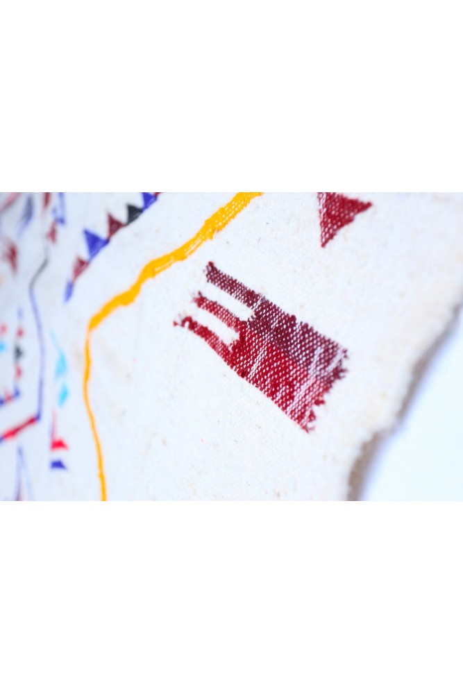 Tapis berbère aux motifs géométriques, couleurs rouge et jaune sur fond crème, artisanat traditionnel marocain.