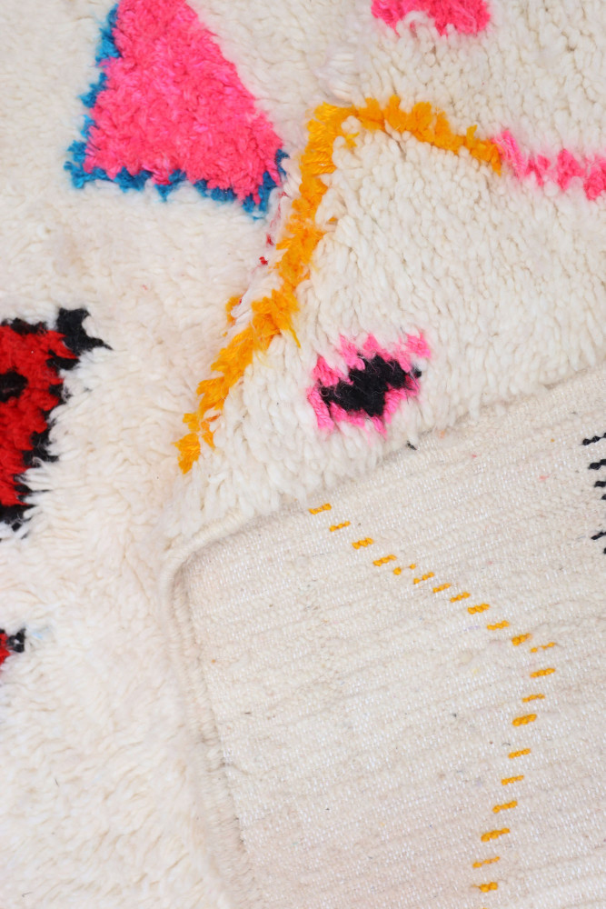Tapis berbère aux couleurs vives, motifs géométriques et texture fluffy, idéal pour un intérieur tendance.