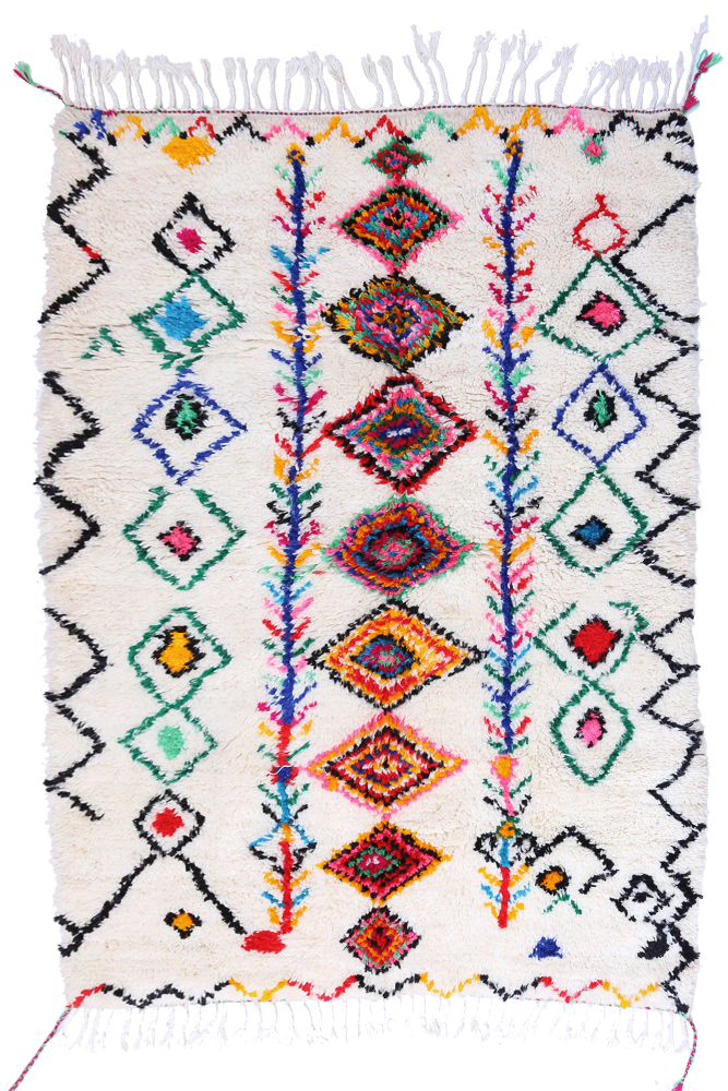 Tapis berbère aux motifs géométriques colorés sur fond blanc crémeux, ajoutant une touche artisanale et chaleureuse.